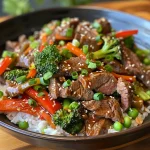 Close-up view of a colorful beef stir fry with vegetables on a plate.