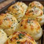 Close-up view of cheesy garlic bombs with gooey melted cheese and buttery crust.