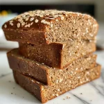 Close-up view of freshly baked Honey Whole Wheat Sandwich Bread, showcasing its golden crust and soft texture.