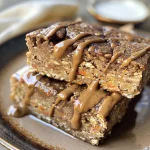 Close-up view of a healthy breakfast bar with visible ingredients like oats and grated carrots.