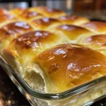 Close-up view of golden-brown no yeast dinner rolls with a soft texture.