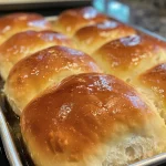 Close-up view of fluffy Greek yogurt rolls, golden brown and baked to perfection.