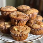 Close-up side view of freshly baked apple cinnamon muffins with a golden-brown top.
