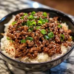 Close-up of a Korean Ground Beef Bowl featuring ground beef, rice, and green onions.