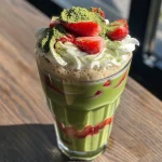 Close-up view of a Strawberry Matcha Latte with vibrant colors.