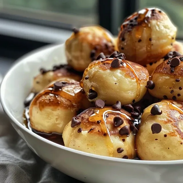 Side view of fluffy High Protein Pancake Bites stacked on a plate, garnished with chocolate chips.