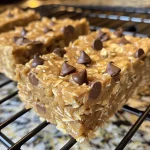 Close-up view of Banana Peanut Butter Oatmeal Bars with dark chocolate chips.