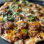 Close-up view of BBQ beef sausage flatbread pizza topped with pickled onions.