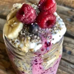 Close-up of Berry Protein Overnight Oats topped with fresh raspberries and blueberries.