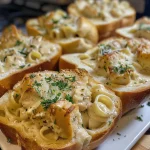 Juicy Chicken Alfredo in a toasted garlic bread bowl with melted cheese.