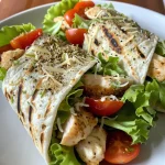 Close-up image of Chicken Caesar Wrap, showcasing juicy grilled chicken and fresh lettuce wrapped in a tortilla.