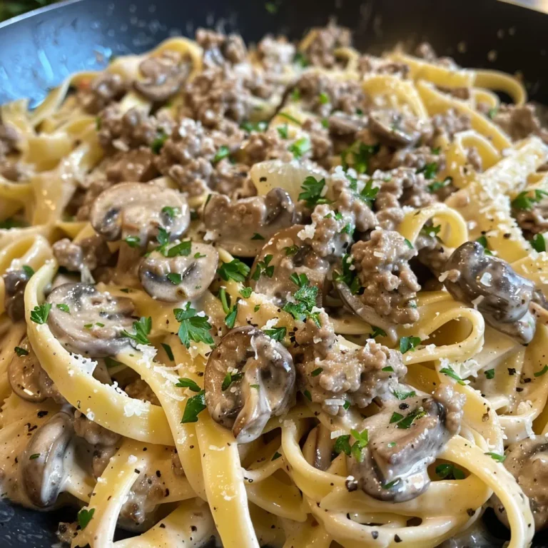 A Cozy Evening with Creamy Beef & Mushroom Pasta That Steals the Show Close-up view of creamy beef and mushroom pasta with rich sauce and herbs.