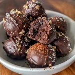 Close-up view of Dark Chocolate Avocado Truffles with a glossy finish.