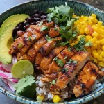 A close-up view of a Honey Chipotle Chicken Rice Bowl with vibrant colors.