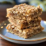 A close-up view of golden Honey Coconut Oat Bars, showcasing their chewy texture.