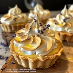 Close-up view of Lemon Lavender Meringue Tartlets with a golden crust and fluffy meringue.