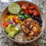 A vibrant Mexican Chicken and Rice Bowl with colorful ingredients arranged artfully.