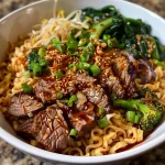 Close-up view of spicy garlic chili oil ramen noodles garnished with scallions and vegetables.
