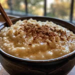 Close-up view of creamy stovetop rice pudding in a bowl.