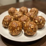 Close-up of peanut butter energy balls on a wooden surface.