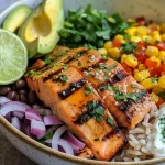 ['Close-up view of Chipotle Honey Salmon Bowl featuring salmon fillets, rice, avocado, and toppings.', 'Side view of a delicious Chipotle Honey Salmon Bowl with vibrant ingredients including black beans and corn.', 'Detailed close-up of a colorful Chipotle Honey Salmon Bowl, showcasing salmon glistening with honey glaze.', 'Mouthwatering Chipotle Honey Salmon Bowl with fresh ingredients, including lime wedges and cilantro.']