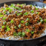 ['Close-up view of a ginger ground turkey and zucchini skillet, showcasing vibrant colors and textures.', 'Juicy ginger ground turkey skillet with zucchini and garnished with green onions and sesame seeds.', 'Side angle of a delicious ginger ground turkey dish featuring sliced zucchini and a rich sauce.', 'Colorful skillet dish with ground turkey, zucchini, and fresh toppings, highlighting a home-cooked meal.']