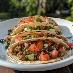 ['Close-up of a Greek-inspired turkey smash burger taco, showcasing juicy ingredients.', 'Juicy turkey smash burger tacos filled with fresh vegetables and feta cheese.', 'Side view of colorful turkey smash burger tacos on a plate, garnished with herbs.', 'Greek-inspired turkey tacos featuring fresh toppings like cucumber and tomatoes.']