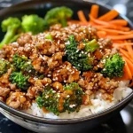 ['Close-up view of juicy ground turkey teriyaki with colorful vegetables.', 'Side view of a plate featuring high-protein ground turkey teriyaki and fresh broccoli.', 'Detailed image of ground turkey teriyaki garnished with carrots and broccoli.', 'Delicious close-up of ground turkey teriyaki dish showcasing vibrant veggies.']
