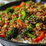 ['Close up of a Honey Garlic Turkey Skillet with colorful vegetables.', 'Juicy Honey Garlic Turkey Skillet featuring ground turkey and broccoli.', 'Side view of a Honey Garlic Turkey Skillet with diced bell peppers and green onions.', 'Delicious Honey Garlic Turkey Skillet prepared with garlic, honey, and spices.']