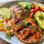 ['Juicy Honey Lime Chicken served over a bed of rice, garnished with lime wedges.', 'Close-up view of tender chicken breasts glazed with honey lime sauce beside fluffy rice.', 'Savory chicken dish with a vibrant lime and honey glaze, displayed with fresh ingredients.', 'Side view of honey lime chicken and rice, highlighting the delicious glossy finish.']