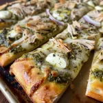 ['Close-up of a Pesto Turkey Flatbread with vibrant toppings.', 'Side view of a juicy Pesto Turkey Flatbread showcasing colorful ingredients.', 'Detailed view of a delicious Pesto Turkey Flatbread, highlighting its fresh toppings.', 'A scrumptious Pesto Turkey Flatbread featuring sliced turkey and pesto.']