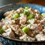 ['A vibrant bowl of turkey salad with fresh ingredients.', 'Close-up view of a refreshing turkey salad with vegetables and herbs.', 'A delicious turkey salad featuring chopped turkey, celery, and scallions.', 'A colorful turkey salad displayed in a bowl with a creamy dressing.']