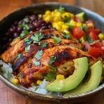 ['Close-up of a Spicy Mexican Tilapia Bowl with vibrant ingredients.', 'Side view of a colorful Spicy Mexican Tilapia Bowl showcasing fresh toppings.', 'Juicy Spicy Mexican Tilapia Bowl filled with rice, beans, and avocado.', 'Detailed photo of a Spicy Mexican Tilapia Bowl highlighting its spicy seasonings.']