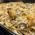 ['Close-up view of a slice of Turkey Tetrazzini Casserole with creamy sauce and pasta.', 'Side view of a Turkey Tetrazzini Casserole showing layers of turkey and cheese.', 'Detailed image of Turkey Tetrazzini Casserole, highlighting pasta and melted cheese.', 'Juicy Turkey Tetrazzini Casserole served in a dish, featuring a golden cheese top.']