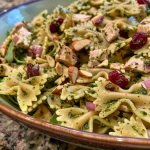 ['Close-up view of Lemon Pesto Turkey Pasta with vibrant colors and fresh ingredients.', 'Juicy Lemon Pesto Turkey Pasta featuring bow tie pasta and a garnish of lemon zest.', 'Side view capturing a bowl of Lemon Pesto Turkey Pasta with chopped turkey and basil.', 'Dish of Lemon Pesto Turkey Pasta, showcasing the creamy pesto sauce and fresh herbs.']