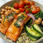 ['Close-up of a Mediterranean salmon bowl featuring grilled salmon, quinoa, fresh vegetables, and yogurt sauce.', 'Side view of a vibrant Mediterranean salmon bowl with salmon, greens, and colorful toppings.', 'Detailed view of a Mediterranean salmon dish showcasing garnished salmon over quinoa and diced veggies.', 'A succulent salmon bowl filled with quinoa, cherry tomatoes, cucumbers, and a creamy sauce.']