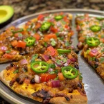 ['Close-up view of a Chipotle Flatbread Pizza topped with fresh ingredients.', 'Side perspective of a tempting Chipotle Flatbread Pizza with visible toppings.', 'Juicy Chipotle Flatbread Pizza showcasing colorful vegetables and sauces.', 'Detailed view of a Chipotle Flatbread Pizza, highlighting its textures and toppings.']