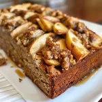 ['Close-up of a slice of healthy apple cinnamon bread with a golden-brown crust and visible apple chunks.', 'Side view of freshly baked gluten-free apple cinnamon bread, showcasing its moist interior and apple pieces.', 'Delicious apple cinnamon bread displayed on a wooden surface, highlighting its texture and cinnamon sprinkle on top.', 'A slice of dairy-free apple cinnamon bread with a soft crumb, featuring diced apples throughout.']