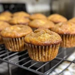 Close-up view of freshly baked apple cinnamon muffins with a golden-brown crust.