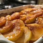 Close-up view of baked cinnamon apples with a shiny glaze.