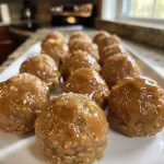 Close-up view of a caramel apple cookie dough bite with a glossy caramel drizzle.