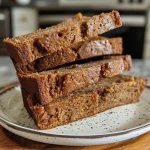 Close-up side view of a moist Chai Spiced Quick Bread with a golden-brown crust.