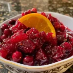 Close-up view of fresh cranberry relish with orange peel visible.