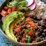 Close-up of a high protein taco bowl featuring colorful ingredients like rice, vegan chorizo, and avocado.