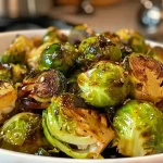 Close-up view of roasted Brussels sprouts drizzled with maple balsamic glaze.
