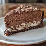 Close-up view of a creamy No-Bake Nutella Cheesecake with a chocolate biscuit crust.