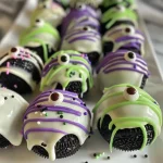 Close-up view of colorful Monster Oreo Balls with candy eyes and sprinkles.