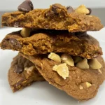 Close-up view of freshly baked pumpkin protein cookies with chocolate chips.