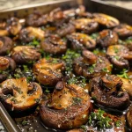 A close-up view of juicy roasted mushrooms glistening with olive oil and herbs.