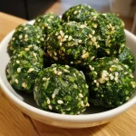 Close-up of a Spinatboller shaped like Frankenstein, with green spinach and details for eyes and mouth.